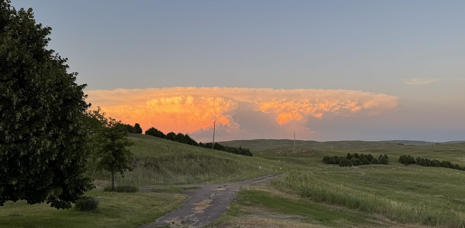 Towering storm cloud at sunset