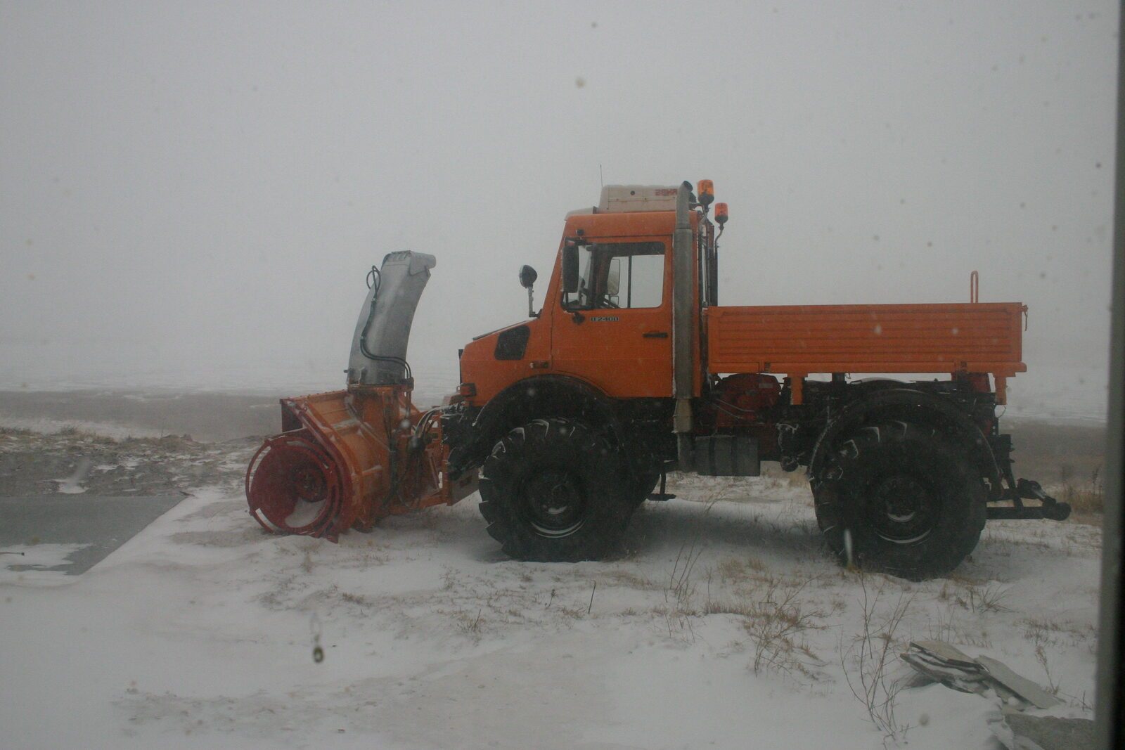 Unimog snowblower keeping ranch roads clear during winter storm
